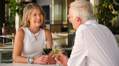 Happy mature couple drinking wine and having a conversation at a restaurant