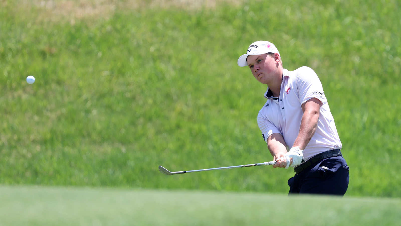 Caleb Surratt hits a chip shot