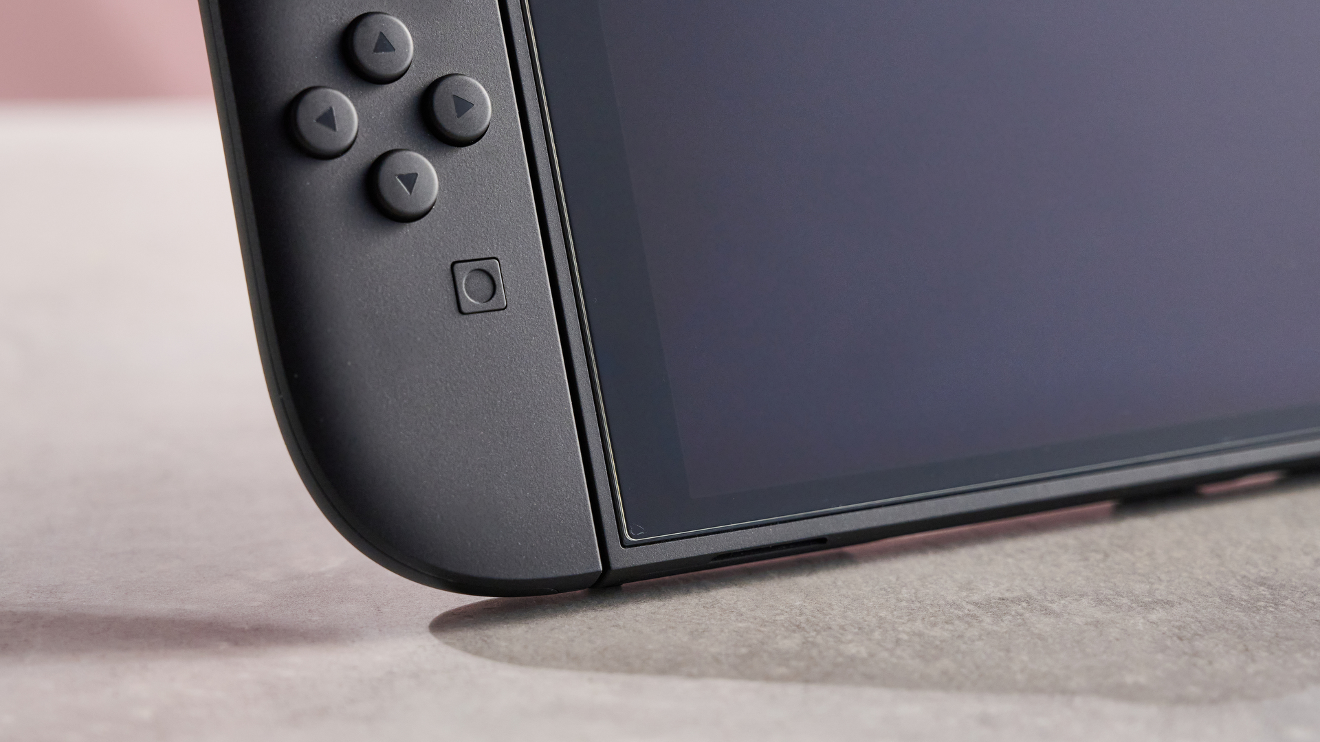 A close-up of the bottom-left corner of the Belkin Temperd Glass Anti-Reflective Screen protector applied to the Nintendo Switch 2.