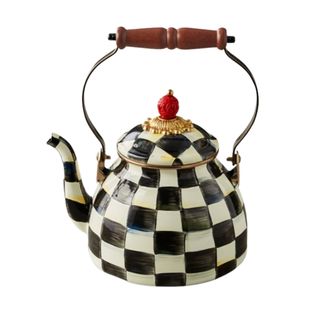 A black and white checkered tea kettle with a dark wooden handle