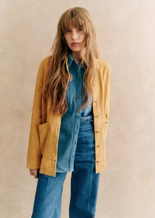 Sezane model in double denim and a camel suede jacket