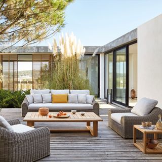 outdoor area with sofa and wooden table