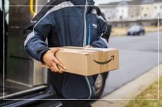 Amazon delivery person carrying an Amazon parcel