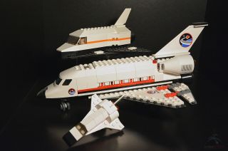— LEGO's mini space shuttle (foreground) resembles the larger toy launched on the real space shuttle Discovery (at top).