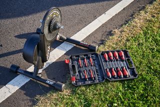 A turbo trainer and a tool kit on the ground