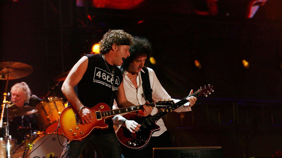 Jamie Moses (Left) and Brian May perform with Queen on stage at the charity concert &quot;46664 South Africa&quot; at the Fancourt Hotel &amp; Country Club on March 19, 2005 in George, South Africa