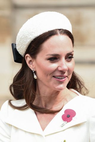 Kate Middleton headshot with a wavy hairstyle and white hat
