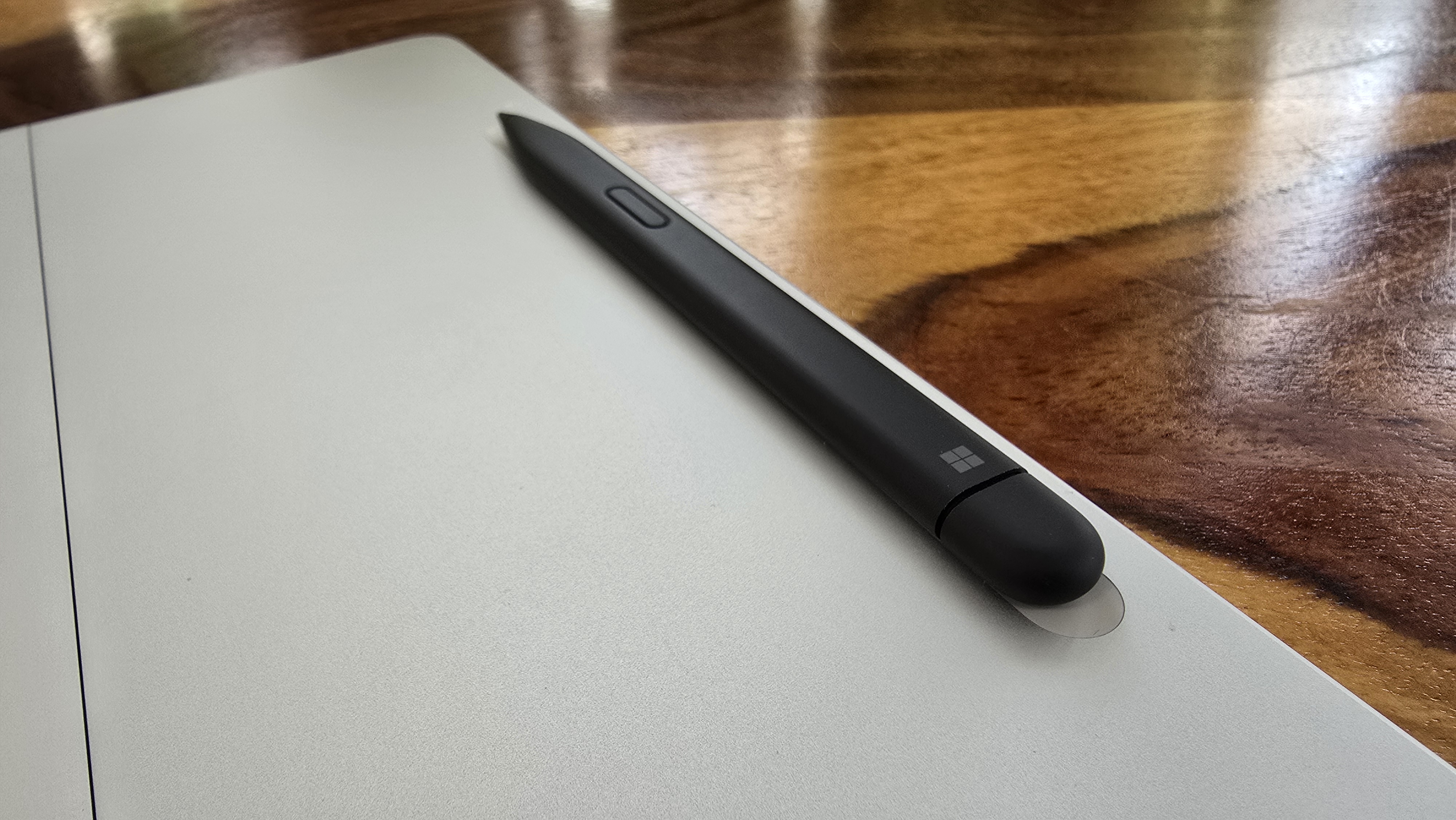 Microsoft Surface Pro 12 tablet on wooden table in relaxed cafe