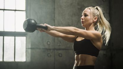 Woman performing a kettlebell swing