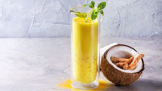 Healthy coconut milk and mint drink with a turmeric smoothie booster