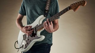 Man playing Fender Stratocaster electric guitar