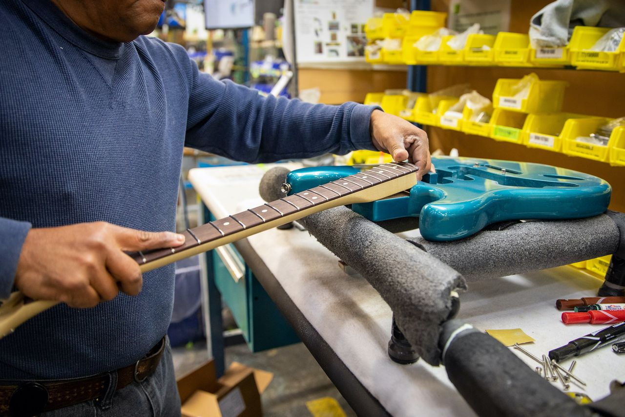 A technician works on a guitar at Fender's Mod Shop