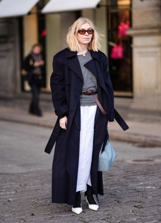 A woman wearing a layered monochromatic outfit