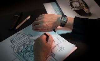 hands sketching watch designs