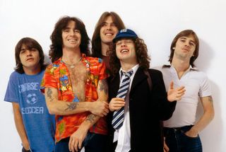 Photo of Bon SCOTT and AC/DC and Angus YOUNG and Phil RUDD and Cliff WILLIAMS and Malcolm YOUNG and AC DC, L-R: Malcolm Young, Bon Scott, Cliff Williams, Angus Young, Phil Rudd - posed, studio, group shot (Photo by Fin Costello/Redferns)