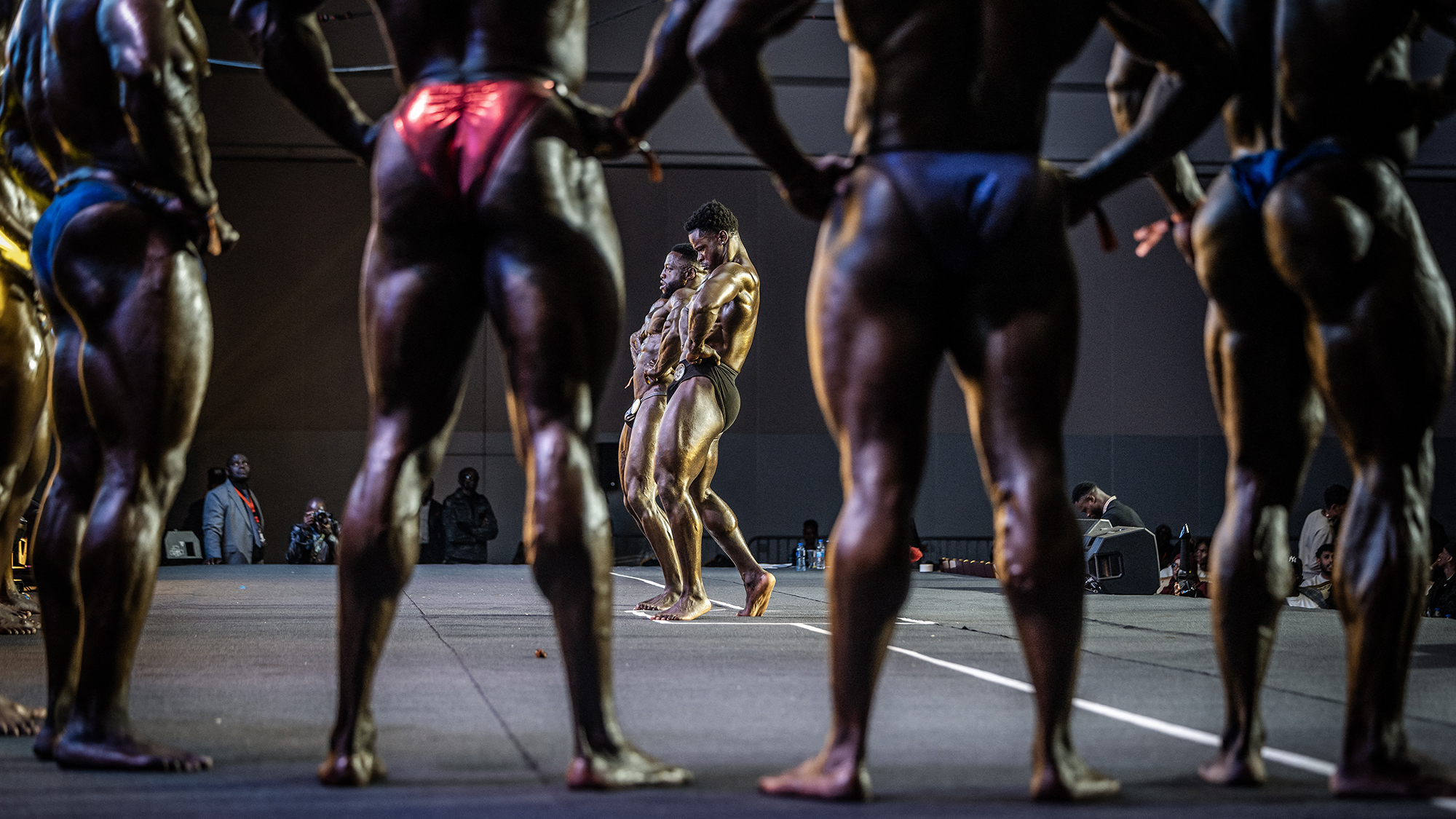 Competitors in the Men's Open Bodybuilding category strike a pose during the 2026 Body Fuel International Fitness Championship in Nairobi, Kenya