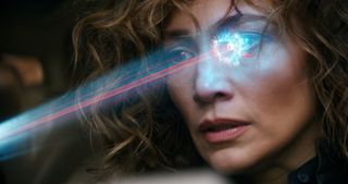 A woman with a glimmering laser light shining in her eye