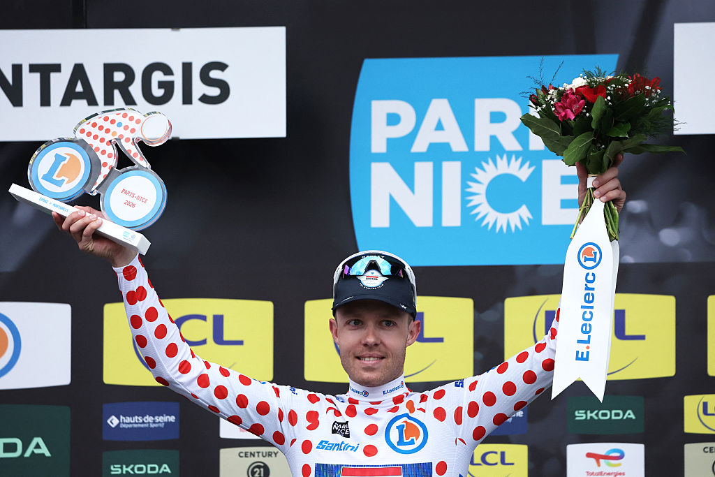 Soudal Quick-Step's Danish rider Casper Pedersen celebrates his white with red polka dots jersey for best climber on the podium after the 2nd stage of the Paris-Nice cycling race, 187 km between &amp;Eacute;p&amp;ocirc;ne and Montargis, on March 9, 2026. (Photo by Anne-Christine POUJOULAT / AFP)