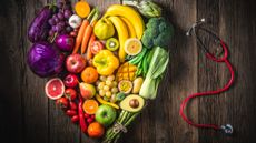 Fruits and vegetables in shape of heart with stethoscope