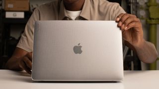 A person using the Apple Incase MacBook hardshell case, one of the best MacBook Air cases