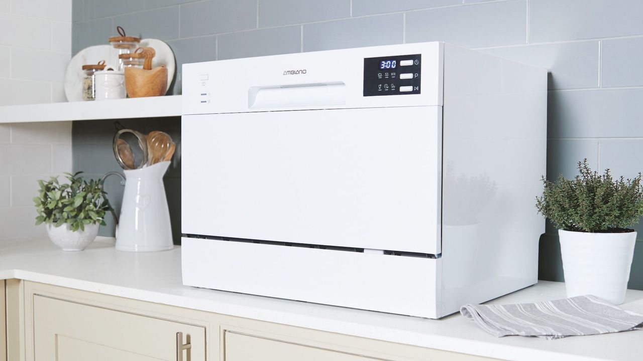 White tabletop dishwasher on kitchen worktop