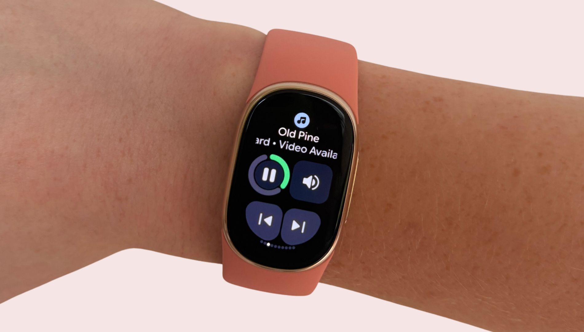Grace Walsh holding Google Fitbit Edge up on arm to show Spotify playing on screen