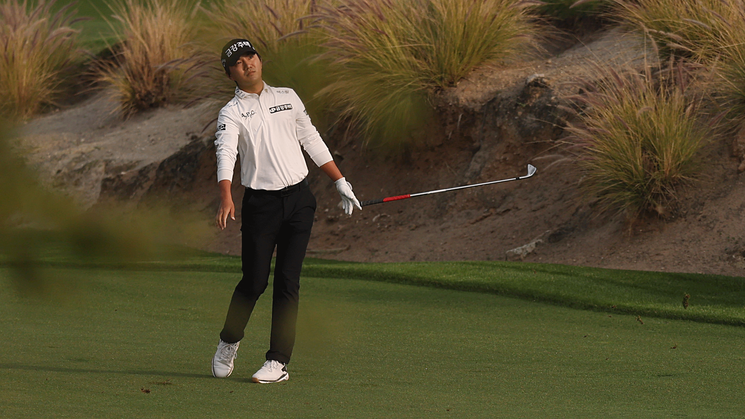 South Korea's Tae-hoon Ok lets go of his iron after hitting a shot during the DP World Tour's Bahrain Championship in 2026
