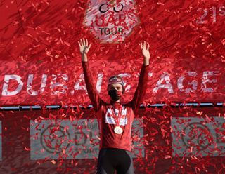 Race leader Tadej Pogacar of Team UAE Emirates celebrates on the podium after the sixth stage of the UAE Cycling Tour From Dubai Deira Islands to Dubai Palm Jumeriah on February 26 2021 Photo by Giuseppe CACACE AFP Photo by GIUSEPPE CACACEAFP via Getty Images