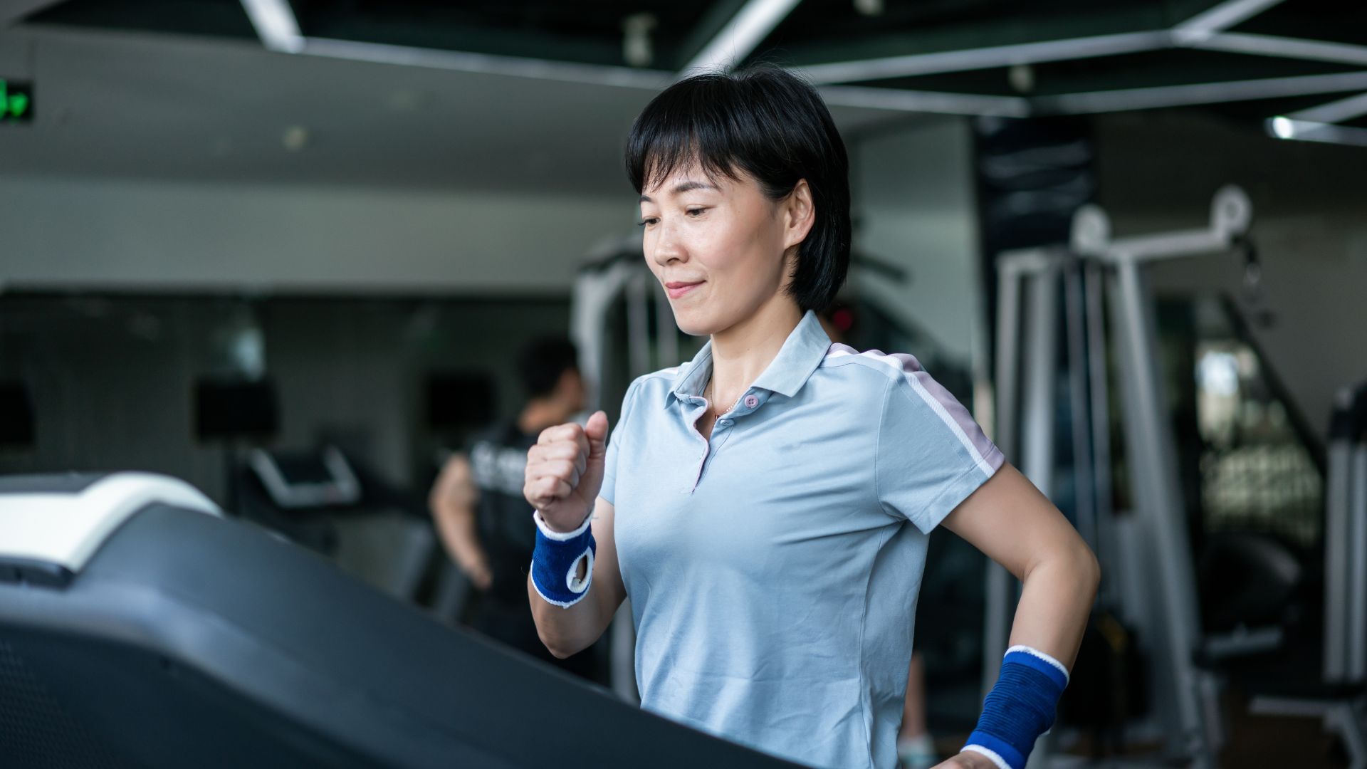 Woman doing incline walking workout at a gym
