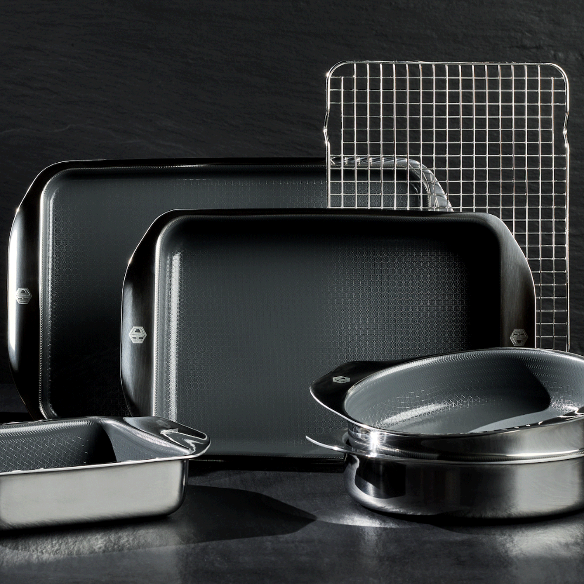 close up of the HexClad Hybrid Bakeware collection against a black background