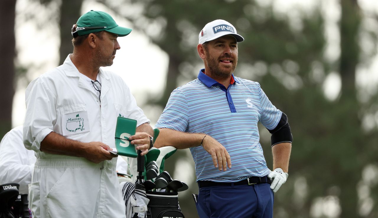 Oosthuizen stands by his caddie during the second round of The Masters