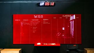 Large rectangular red board with WOD written on it in gym