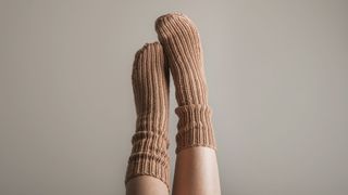 A person wearing a long pair of cosy socks