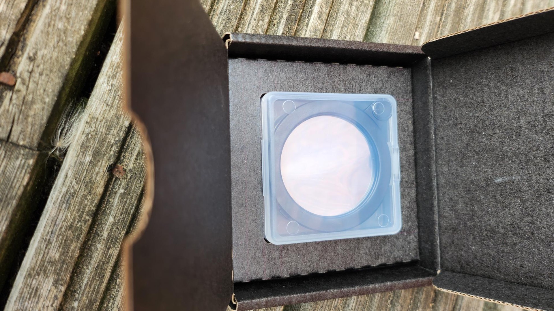 A close up of the Vaonis solar filter in a square brown box.