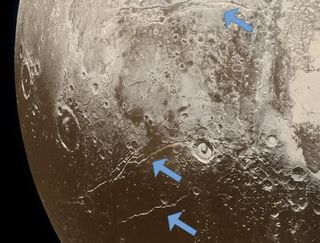 Arrows mark the location of extensional faults on the surface of Pluto that indicate expansion of its crust, which scientists think is due to the freezing of a subsurface ocean.