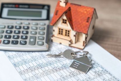 Model house, calculator and keys