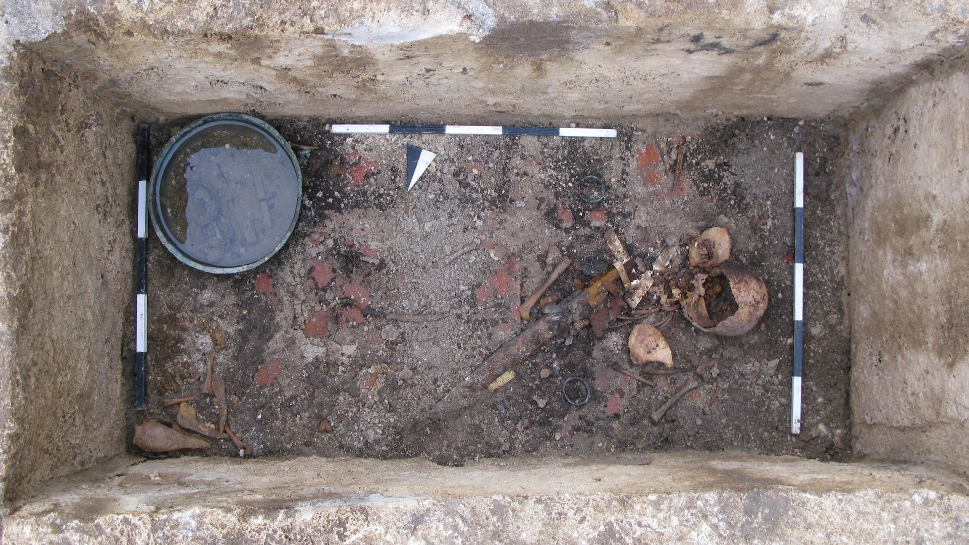 a top-down view of a grave with a skeleton in it