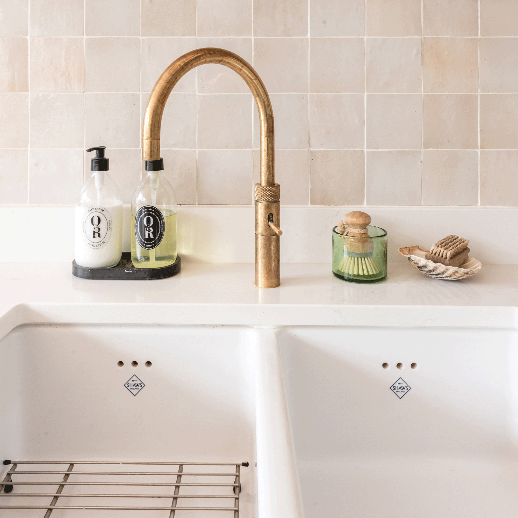 close up of a double Belfast sink with a brass hot water tap