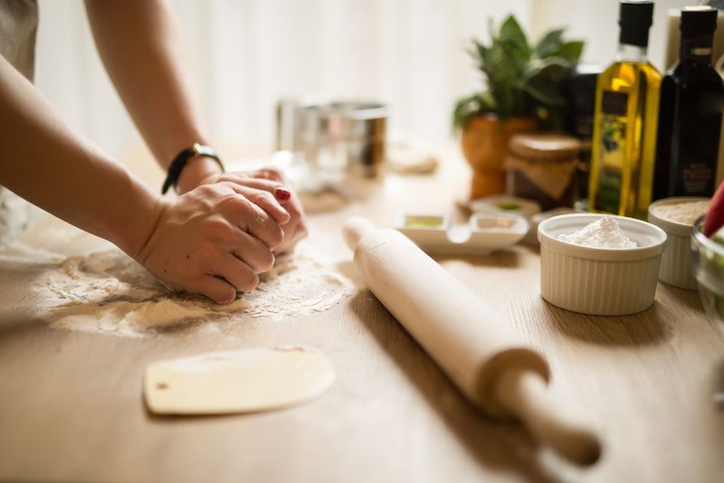 A woman cooks with flour.