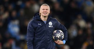 Erling Haaland of Manchester City celebrates victory with their match ball after scoring a hat-trick in the UEFA Champions League round of 16 leg two match between Manchester City and RB Leipzig at Etihad Stadium on March 14, 2023 in Manchester, England.