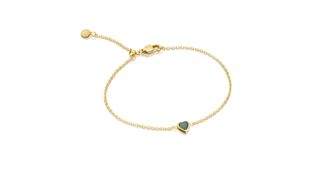 A gold bracelet with a mini green heart for the best personalized jewelry gifts.