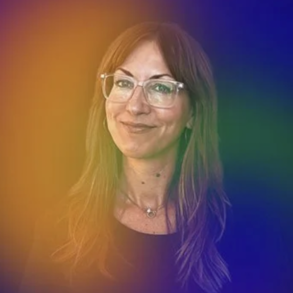 A headshot of a woman with brown hair and glasses