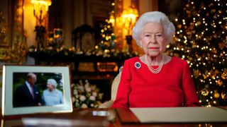 Queen Elizabeth II records her annual Christmas broadcast in the White Drawing Room at Windsor Castle on December 23, 2021 in Windsor, England. The photograph on the desk is of The Queen and the Duke of Edinburgh, taken in 2007 at Broadlands, Hampshire, to mark their Diamond Wedding Anniversary
