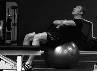 Chris Hoy relaxes on a gym ball