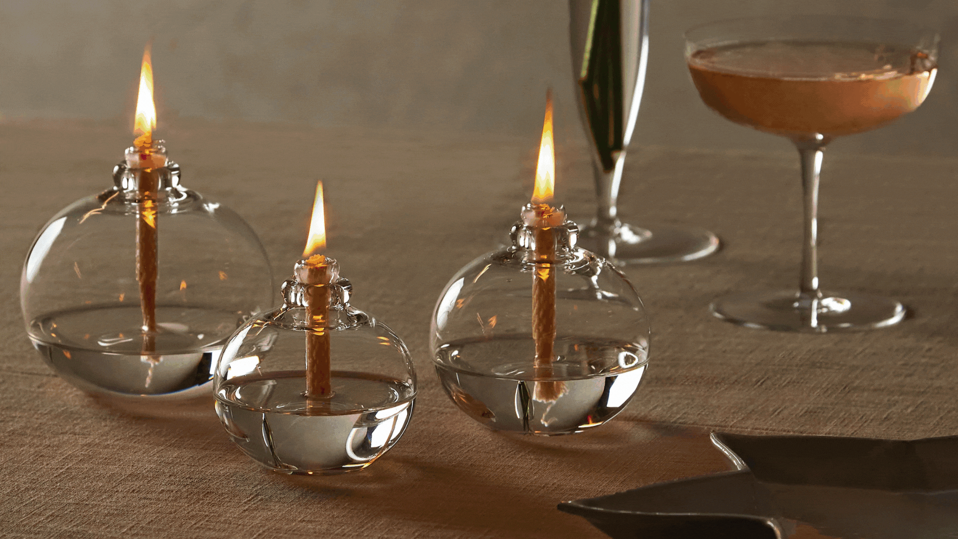 A GIF of oil lamps on a dining table, a coffee table, a side table, and a styled setting