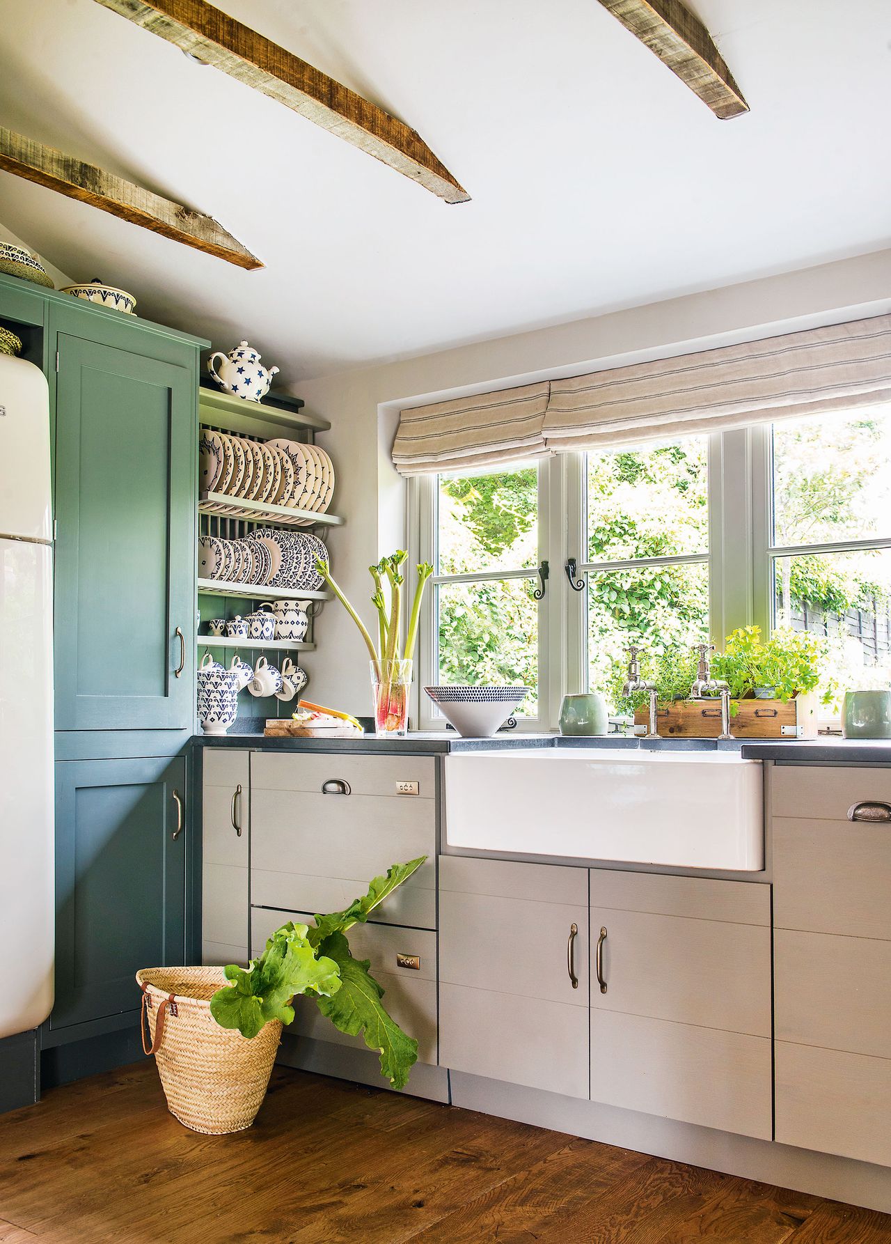 kitchen sink with beams green cabinets and pale base cabinets