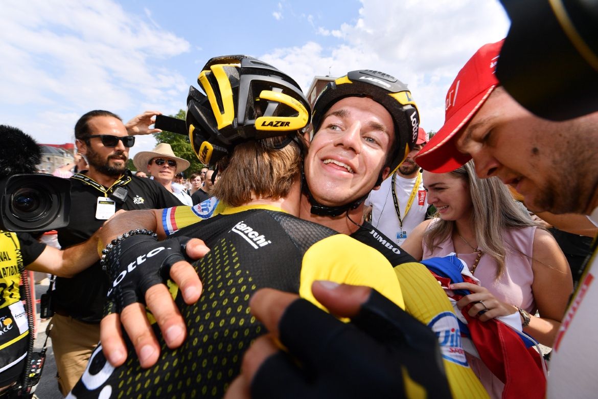 Dylan Groenewegen hugs his teammates