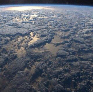 Clouds cast shadows on the surface of the Earth in a photo taken from the International Space Station.