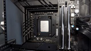 An Arctic Liquid Freezer III Pro liquid cooler set-up on a test bench with the RGB enabled.