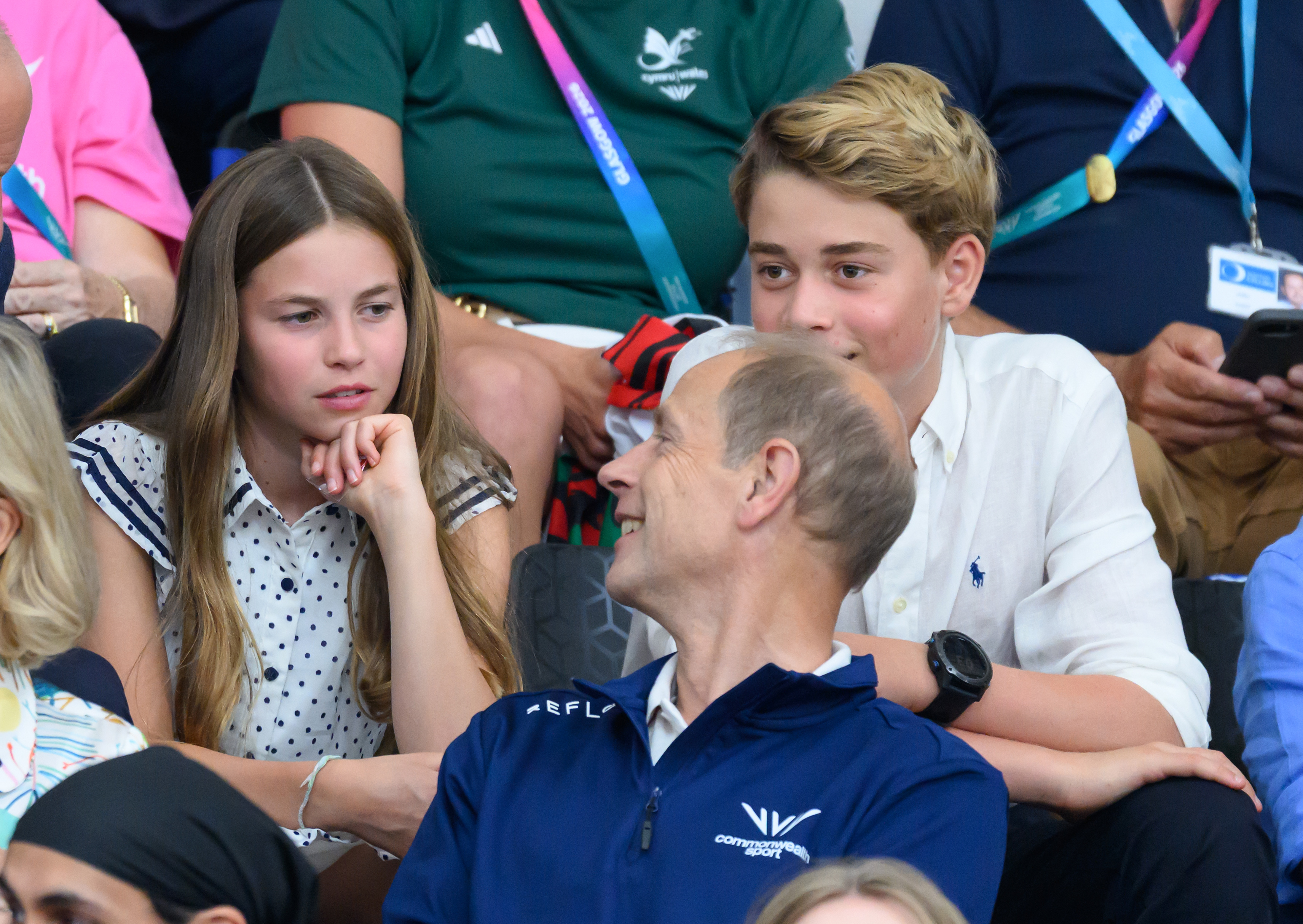 Princess Charlotte and Prince George talking to Prince Edward in their seats at the Commonwealth Games